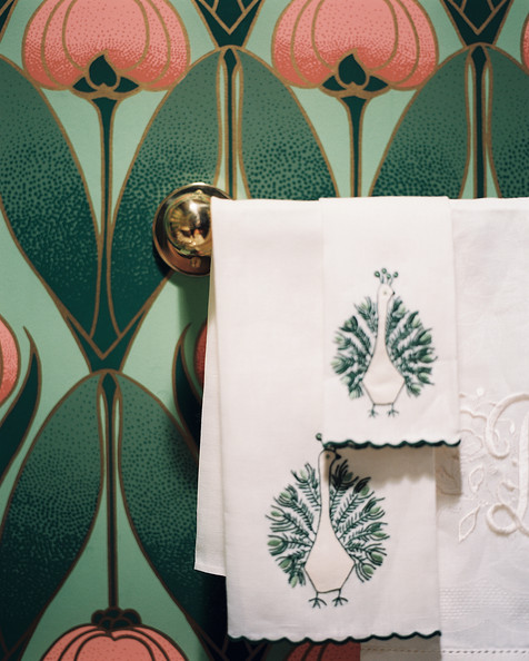 Hollywood Regency Wall Treatment - Monogrammed and embroidered hand towels in a powder room with floral wallpaper