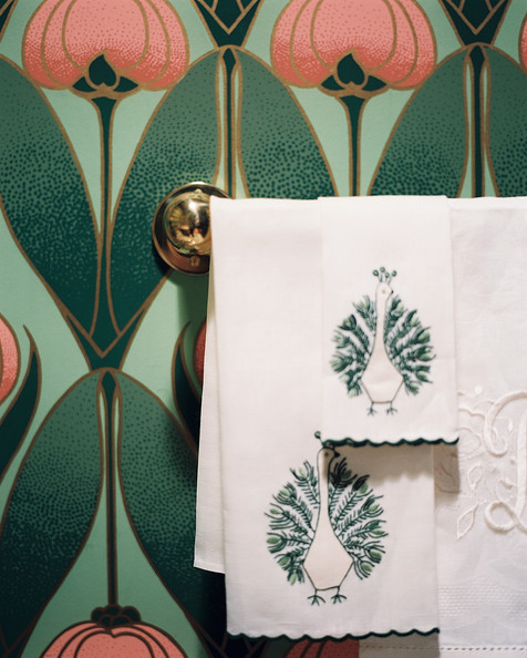 Hollywood Regency Wall Treatment - Monogrammed and embroidered hand towels in a powder room with floral wallpaper